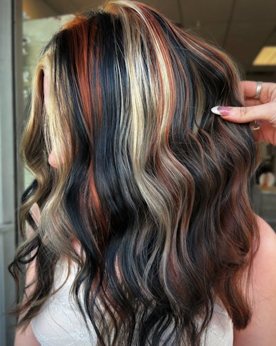 Blended calico hair trend with blonde, red and black strands