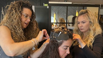Jennifer Janisch and Chloe Hartnett installing Adored Hair Extensions on a client.