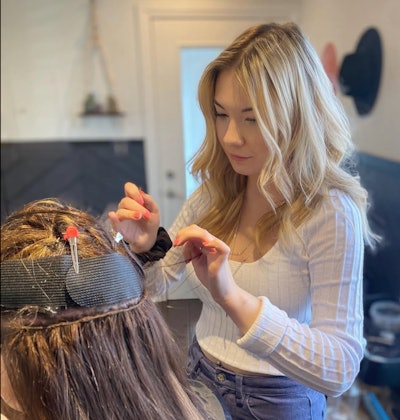 Chloe Hartnett installing Adored Extensions on a client.