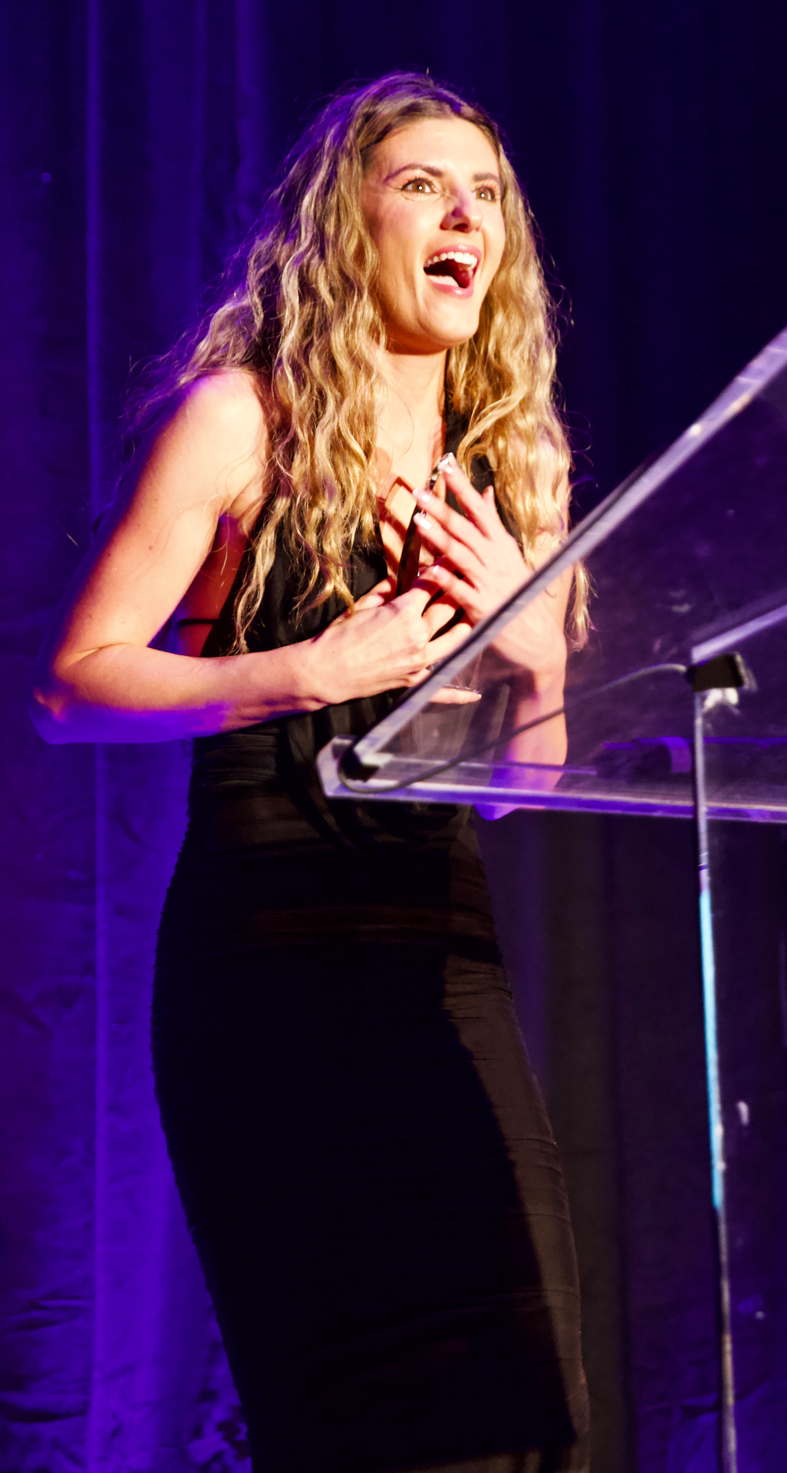 Nina winning an award at the Beyond the Ponytail Styling Awards.
