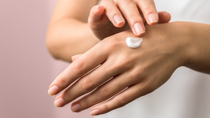 female hands using rich lotion