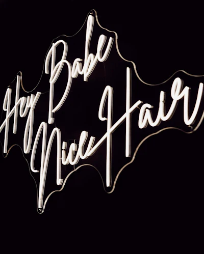 'Hey Babe, nice hair' neon salon sign inside Capelli & Co salon.