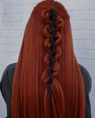 An intricate braiding style on red hair created by Nina Muresan