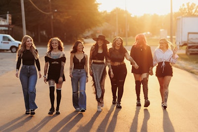 Fringe and Ink Creative Company team walking on a street during golden hour.