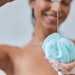 Woman In Shower Pouring Gel On Loofah Adobe Stock 382972380