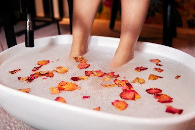 Client soaking feet in a pedicure tub