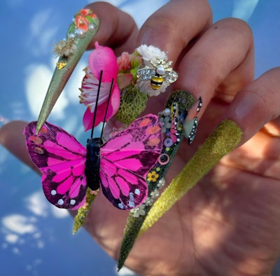 Textured nail art that features charms with butterflies, bees and flowers by @the_nail_ronin