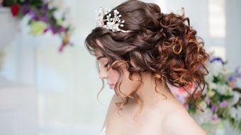 Bride wearing a crown and a wavy updo.