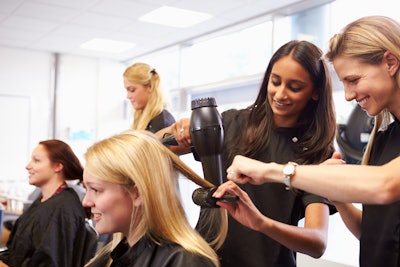 Hairstylists working together in a salon.