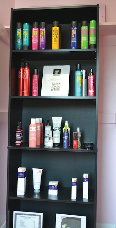 Black shelf of hair products at 100% U Salon