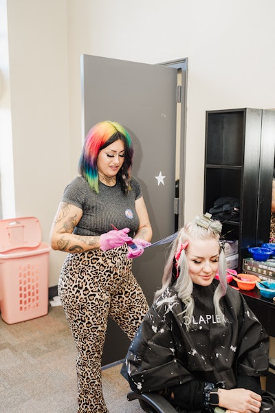 Lynda Peterson coloring a client's hair.