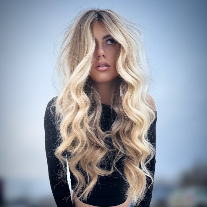 A TREND Model sporting wavy, blonde hair.