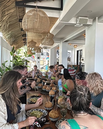 Attendees sharing a meal together at Hair Escape retreat.