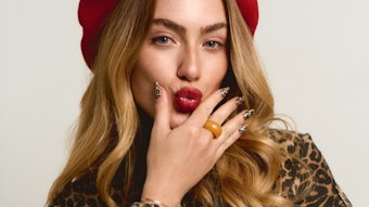 Model in a red beret and leopard print jacket wearing Twisties' leopard print design.
