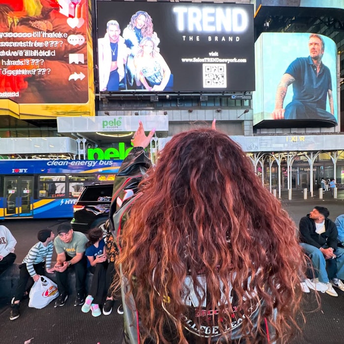 Sherette looks at TREND The Brand billboard in Times Square.
