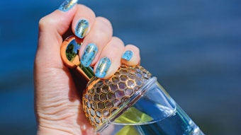 Gold nail stamp art on a blue polish base