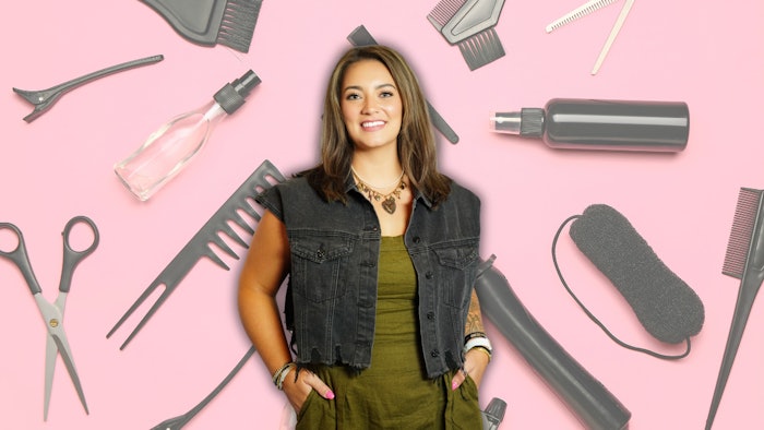 Erika Zabel headshot against a pink background covered in hair tools.