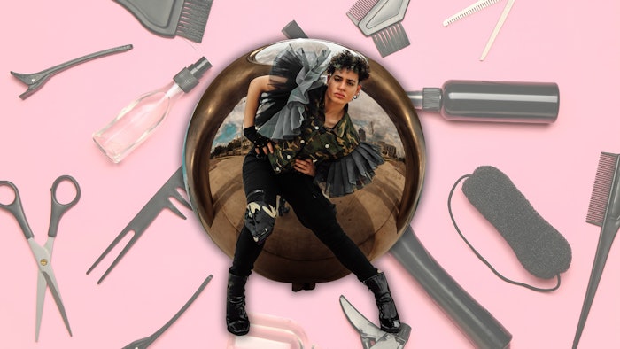 AJ Jubran headshot against a pink background with hair tools.