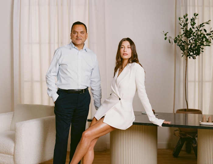 The brand has reportedly more than doubled its consumer base over the past year, racking up $212 million in net sales in the 12 months ended March 31, 2025. Pictured, from left, is e.l.f. Beauty CEO Tarang Amin and Rhode founder Hailey Bieber.
