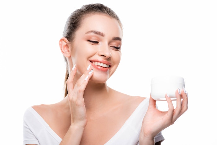 White Background Caucasian Woman Holding White Jar Of Skin Cream Smiling