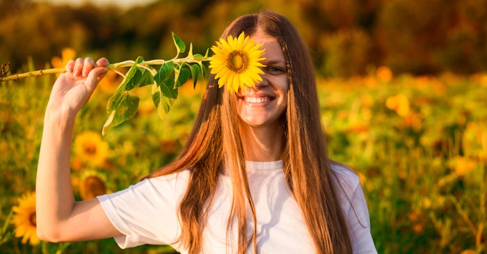Woman In Sunflower Field Flower Over One Eye Arm Up Smiling Adobe Stock 263886931