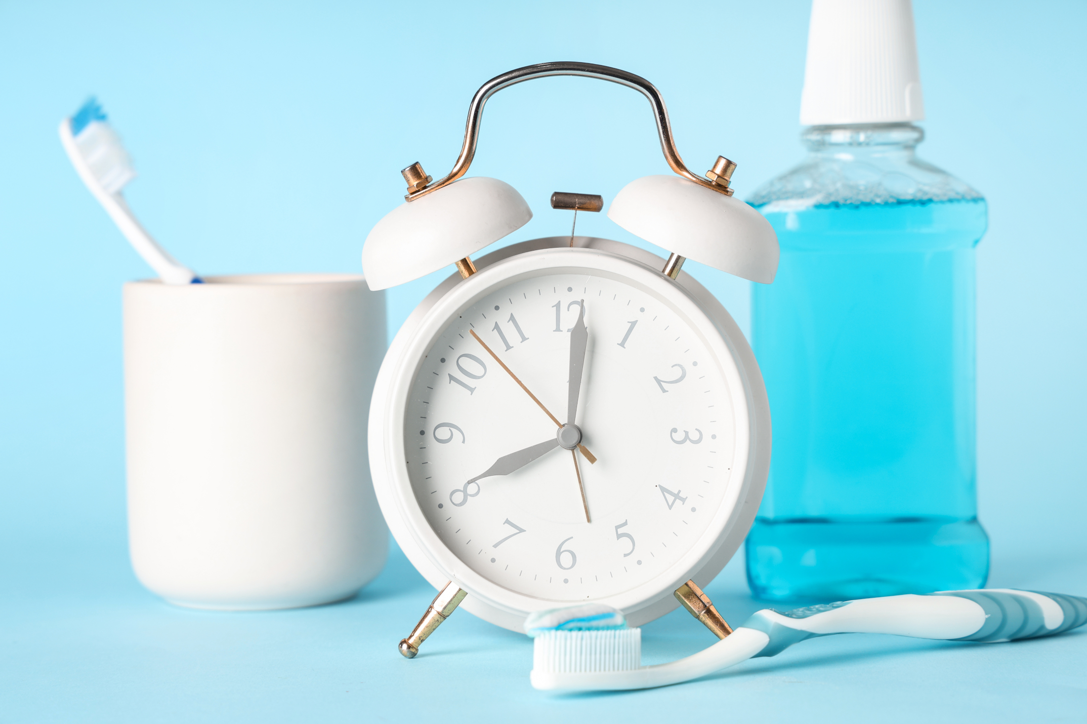 Clock Toothbrush Mouthwash Blue Background Adobe Stock 1352350501