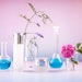 Products Beakers Floral Blue Liquid Pink Background Adobe Stock 524695694