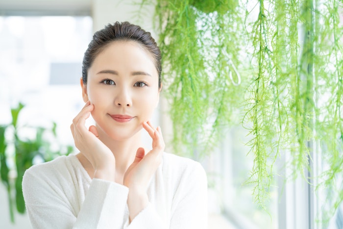 Beautiful Asian Woman White Background Bright Plants Hanging Nearby Natural Skin Care Concept Adobe Stock 278715489