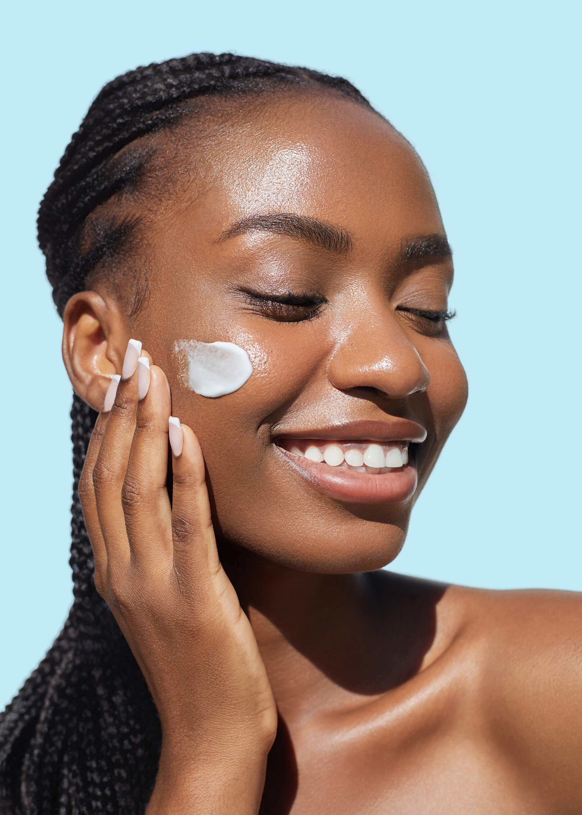 Beautiful Black Woman Using Skin Cream On Face Smiling Relaxed Adobe Stock 1697728328