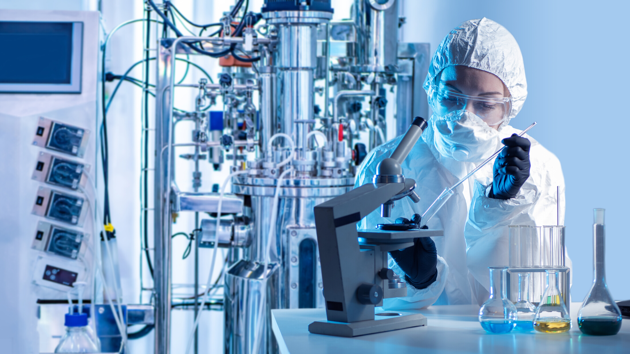 Scientist In Lab Near Bioreactor Inspecting Samples Adobe Stock 647855538