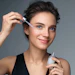 Young Woman Smiling Using Facial Serum Clean Beauty Concept Adobe Stock 368599793
