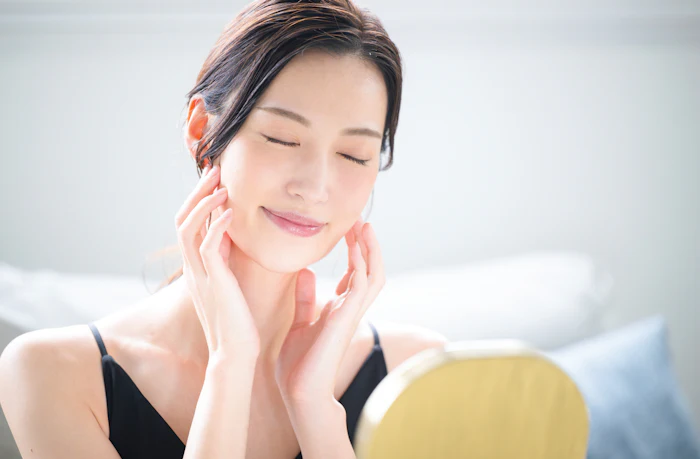 Jd Jojoba Beautiful Young Woman Relaxed Feeling Her Face Mirror Adobe Stock 1014461013