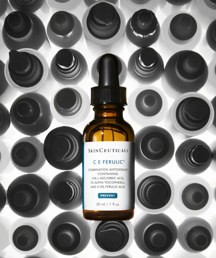 SkinCeuticals C E Ferulic antioxidant serum bottle with dropper displayed against black and white bottle cap background