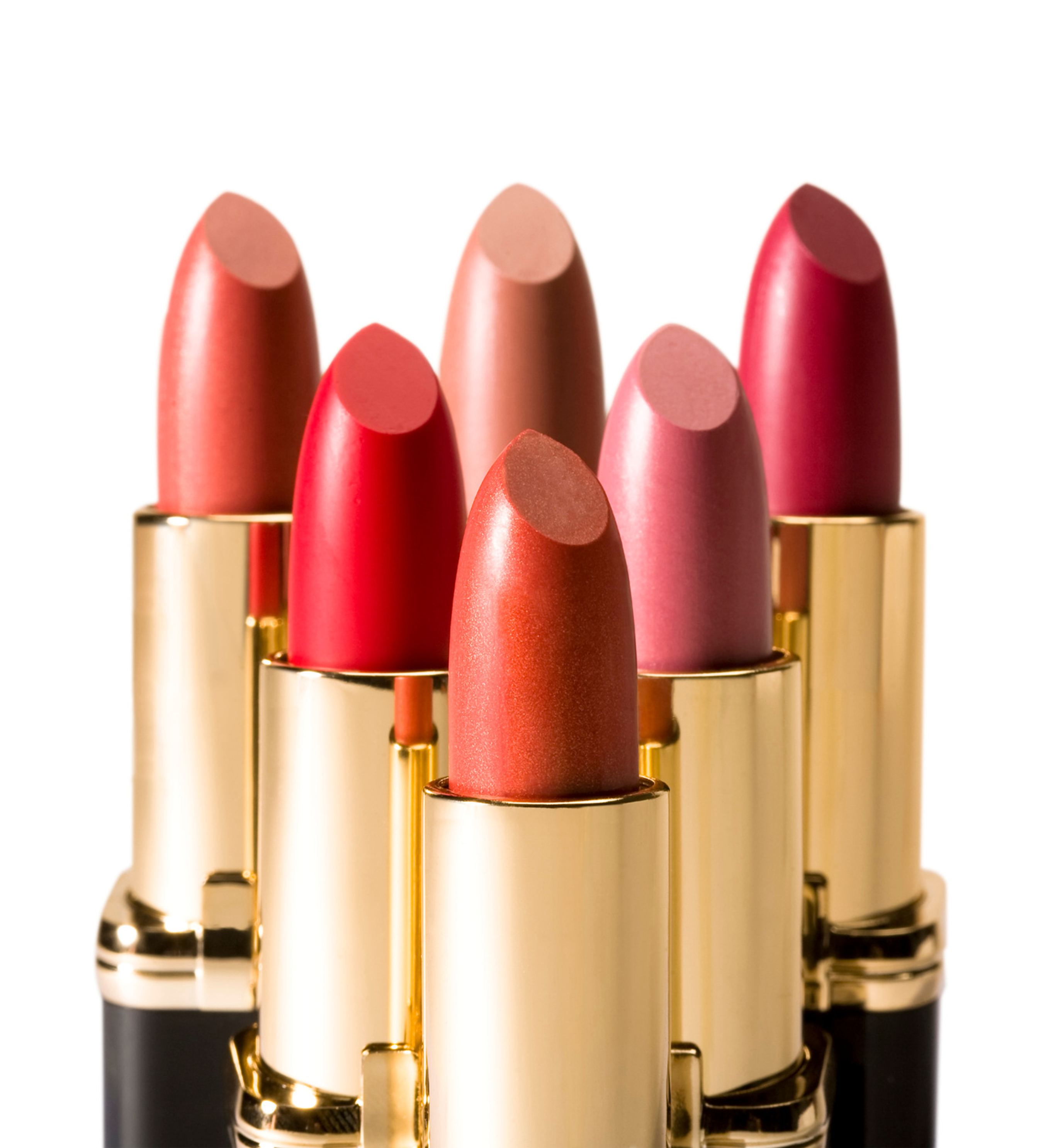 Five luxury lipsticks in varying shades of red and pink with gold tubes arranged in a display