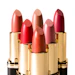 Five luxury lipsticks in varying shades of red and pink with gold tubes arranged in a display
