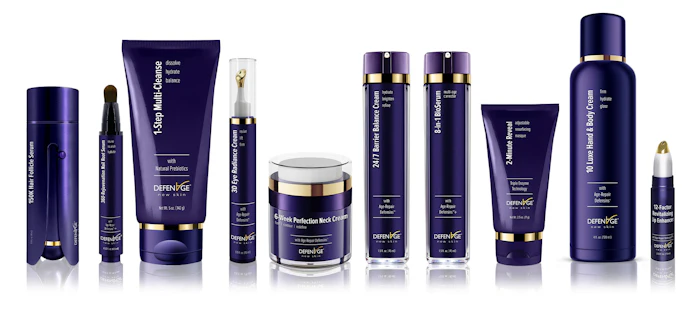 OXYMEDGE skincare product collection featuring purple bottles and containers with gold accents arranged in a row