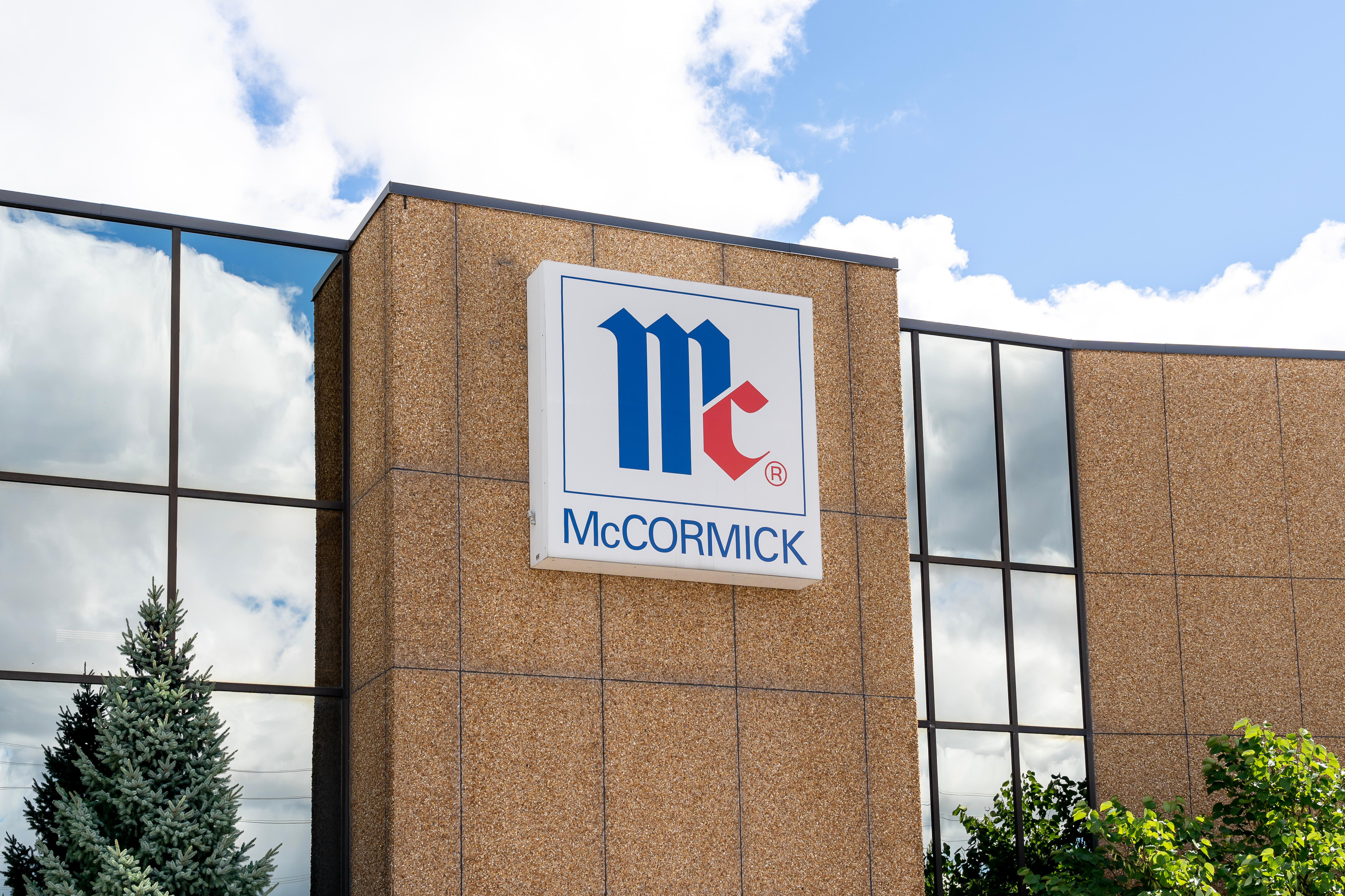 McCormick company logo displayed on brick building exterior with blue and red geometric design