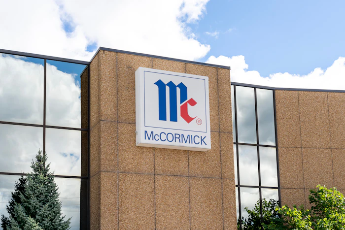 McCormick company logo displayed on brick building exterior with blue and red geometric design